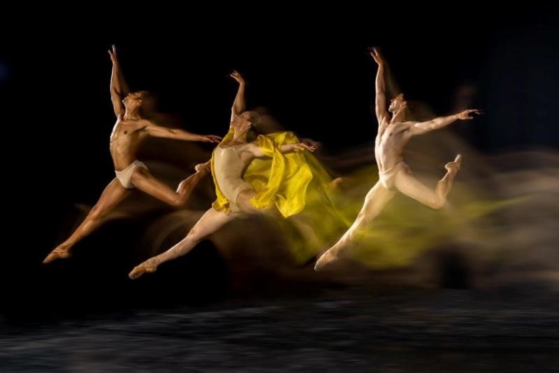 Dancers jumping through the air above the stage