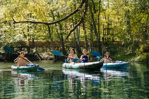 A family kayaks along the calm waters in Alachua County, Florida. 