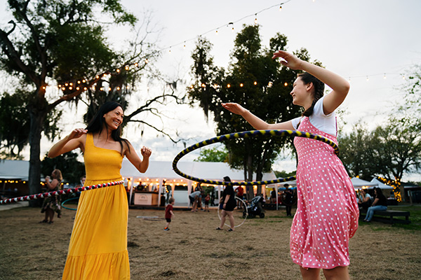 Two young ladies laugh as they hula hoop outside in Alachua County, Florida. 