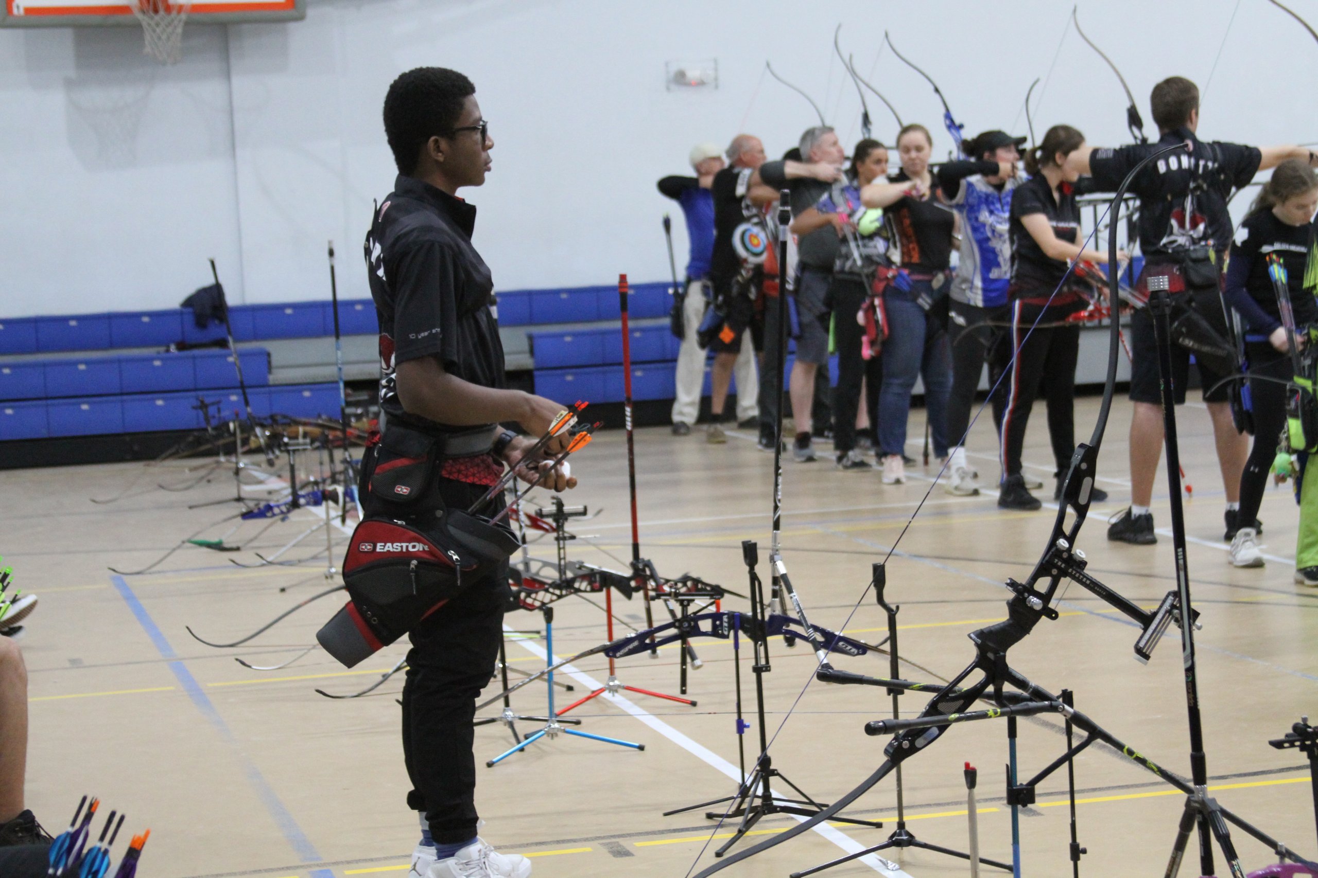 archers at indoor event receiving instructions