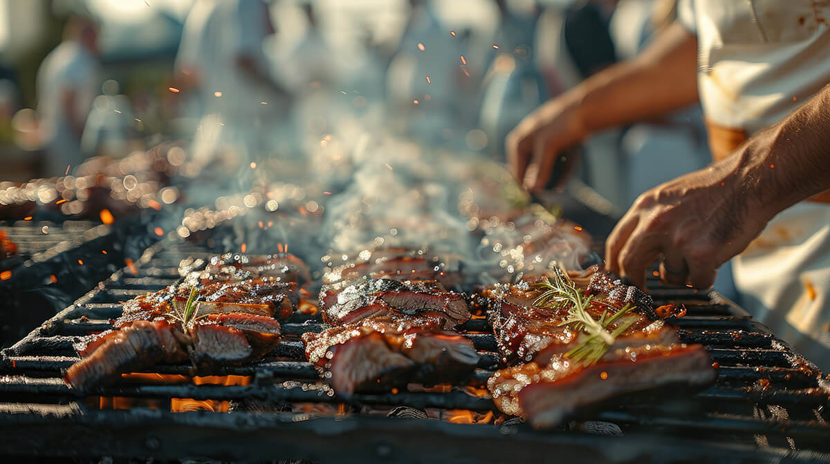 food cooking on bbq grill with people in the background