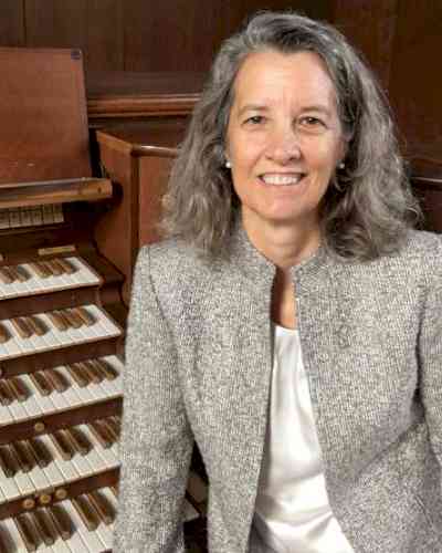 Dr. Laura Ellis next to organ keyboard