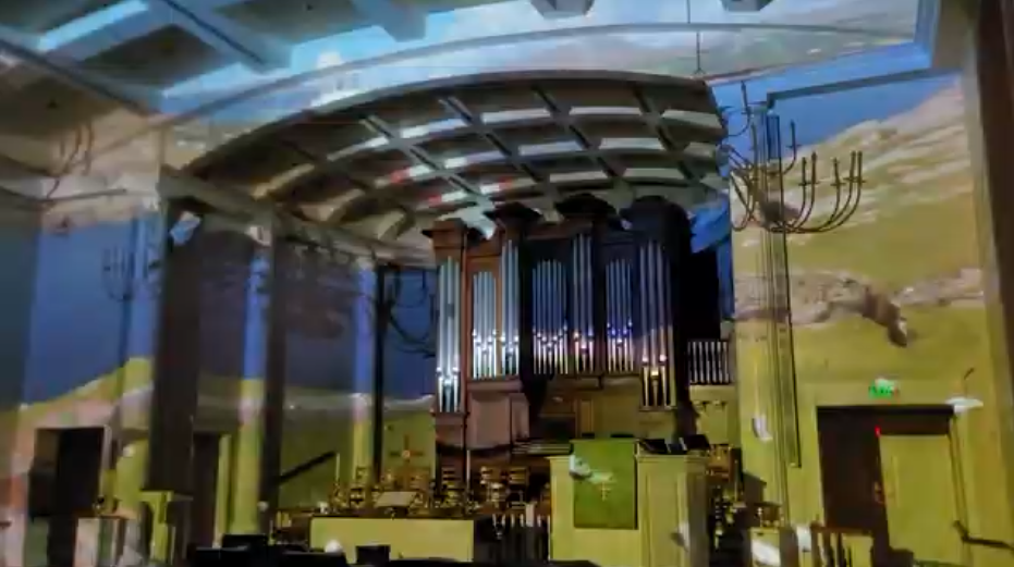 image projected against the pipe organ and walls of the church